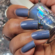 Sassy Cats Lacquer continues their 'For the Love of Cats' theme with a polish inspired by galaxy kitties!

"A Bit Purr-suasive" is a matte dark slate grey base with blue micro shimmer & glowy blue shimmer plus fine holo. May lean blue due to shimmers in different lighting.

15ml Bottle

100 Cap