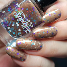 Color Spectrum Polish continues their 'Shrek' series with a polish inspired by Gingy the Gingerbread Man!  "Not My Gumdrop Buttons!" is a sheer brown with copper shimmer, red holo glitter and white, powder blue and purple dots.  12ml Bottle