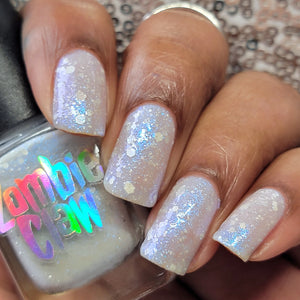 Zombie Claw continues their 'Powerpuff Girls' series with a polish inspired by Bell from Strongershine Girls!  "Girly Girl" has a white gray base with electric blue shimmer, a dash of reflective glitter and white glitters.  13ml Bottle