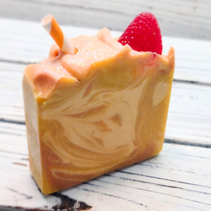 The next in this theme is a luxurious moisturizing goat milk soap inspired by the creamy and fruity Smoothie. It is a beautiful swirl of yellow, peach and orange with a strawberry glycerin soap garnishing the top along with a paper straw (remove before use). Also topped with a dusting of bio-degradable cosmetic glitter.  The scent is a scrumptious blend of creamy vanilla, juicy orange, sweet pineapple, strawberry and maraschino cherry.&nbsp;