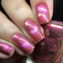 Indie Polish by Patty Lopes continues their 'Amazônia' series!

"Beauty Lilies" (topper) is a light pink magnetic with iridescent flakies.