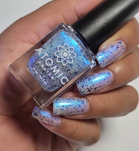 Atomic Polish continues their 'Board Game' series with a polish inspired by Galaxy Trucker!

"Galaxy Trucker" is a sheer polish with a vibrant blue to purple aurora shimmer. It contains holographic pigment and flakes and chameleon flakes that shift from red to blue.