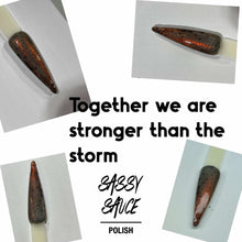 Sassy Sauce Polish will be donating 20% of proceeds to the World Central Kitchen https://www.wck.org.

"Together We are Stronger Than the Storm" is a black jelly with black flakes and a red/ copper shimmer.