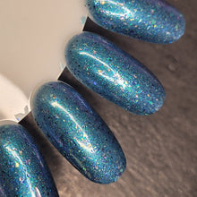 Paint It Pretty Polish will be donating $2.50 per bottle to All Hands and Hearts.

"Helping Hands" is a dark blue based polish with a turquoise to purple shimmer, assorted crystal chameleon flakes, dark blue flakes, and a holographic finish.