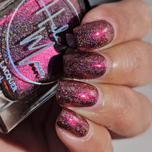 "The Two Yutes" is a deep rich cabernet hue that has small shifts between brown, wine, and some peeks of plum. It is infused with holographic glitter but still manages to capture the suit’s vintage flair.

15ml Bottle