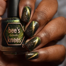 "The Lusty Argonian Maid" is a black polish with gold to green mutlichrome magnetic shimmer and a scattering of holo flakes.

15ml Bottle