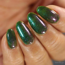 "Goblin Zogga " has a green ivy base with silver reflective glitter and purple mauve pigment.

13ml Bottle