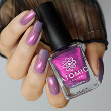 "Not To Brag..." has a pale violet base with a red/pink shift and holographic micro flakes. A more sheer and shifty formula that is opaque in 3 coats.

15ml Bottle