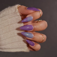"Goin’ Dahntahn" is a thermal with shifts of light blue, purple and dark blue with a scattered holo shimmer and silver reflective glitter.

15ml Bottle