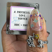 "Mom's Love" is a a glittery topper with teal butterflies, silver &amp; purple hearts, raspberry, mosaic &amp; gold micro glitters.
Will include a pot of extra glitters.
NOTE: Some swatches shown over various base colors.

15ml Bottle