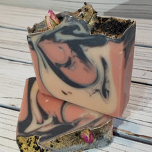 This moisturizing goat milk soap features a beautifully swirled pink and black base and includes activated charcoal for extra complexion benefits. Tiny dried real rosebuds adorn the top along with gold mica, black cosmetic glitter, and Hawaiian Black Lava Salt, creating a dramatic and elevated finish worthy of a goddess.