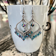 These gorgeous earrings feature Moroccan-inspired antique silver finished frames adorned with tropical blue rondelles in a sparkling aurora borealis finish. Each faceted bead reflects the light with a brilliant, color-shifting sparkle.

You’ll love wearing these iridescent beauties with everything from casual jeans to flowy dresses and beyond. They also make a wonderful gift, so be sure to pick up an extra pair for someone special.

Earrings measure just under 2.5" long