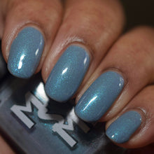 "Dreamlight Winter Ball" is a snowy blue-gray glowing with three shimmers shifting aqua/sapphire, fuchsia/blue/purple, and green/teal.

15ml Bottle
