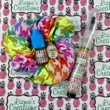 Scrunchie+ Design – an array of colored houndstooth fill up this design with a white zipper
Items - Scrunchie+ with 2ml cuticle oil inside scented with Pride Loudly
With a 5ml refill bottle and a 6ml CutiPen Refillable Cartridge scented with Pride Loudly
Scent - Pride Loudly - a playful, tropical fruit mix of sweet banana, strawberry, kiwi, and pineapple.