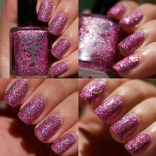 "We're All Mad Here" is a pink holographic glitter bomb with a touch of silver holo flakes.

12ml Bottle