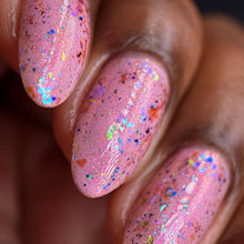 "Puu" has a baby pink base with pink/golden aurora shimmer.

"Dimensional God" is a topper that has a mix of iridescent flakies and blue/purple multichrome flakies.

10ml Bottles