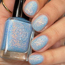 "Uncle Rad" is a pale baby blue crelly with orange/gold glass flakes and holo flakes.

12ml Bottle