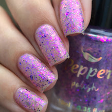 "Mystic Shards" is a clear topper filled with a mix of pink and purple iridescent flakes and purple metallic micro flakes.

10ml Bottle