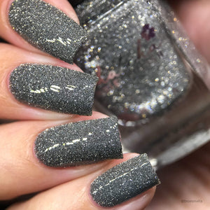 Whatcha Indie Polish continues the series inspired by the Periodic Table with "22 Ti" which is a reflective graphite polish.