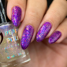 For the holidays, Pepper Polish has created two polishes inspired by a Christmas sunset!

"Sunset Christmas" is a beautiful combination of a purple gelatin base with iridescent purple/pink/red flakes and black microflakes.

"Golden Lights" adds beautiful golden highlights and a bluish glow to your nail polish, with its clear base featuring a small blue/purple/gold aurora and iridescent orange/green flakes and fine gold glitter.