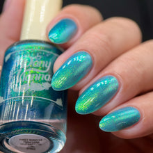 By Dany Vianna continues their 'Fruits Basket' series with a polish inspired by moments from the series!

"First Sunrise Together" has a sheer blue base with a sparkling large particle gold to green aurora shimmer.