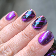 "Shadowed Witch" is a multi-color, magnetic purple polish with a smoky base and turquoise and purple microflakes that dance in the light, creating a mesmerizing effect.

This polish is part of an exclusive kit that includes a glow-in-the-dark ghost magnet that creates waves (on long nails) or circular effects on your nails, perfect for completing your magical and stylish experience.
*The polish was magnetized with other magnets as well so you can see how it looks with other effects.

10ml Bottle