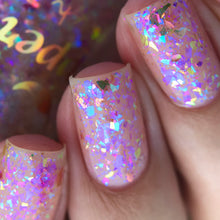 "Iridescent Veil" is a topper with a mix of blue and purple iridescent flakes, with a touch of orange.
*Note: Some swatches shown over a base color.