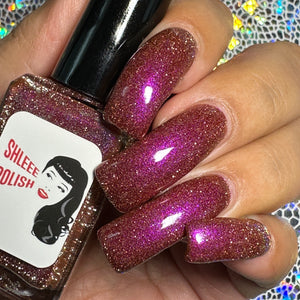 Shleee Polish continues their 'Disney Sidekick' series with a polish inspired by Pain from Hercules!

"Pain" is a pink/violet shimmer, and silver reflective glitter in a brick colored base.