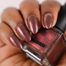 Cracked Polish continues their 'Follow Me Down The Indie Rabbit Hole' with a polish inspired by the Mad Hatter's vibe, channeling the whimsical chaos of Johnny Depp's iconic blazer!

"Magic Not Miracles" is a reddened plum with pink and holographic shimmers, it's like a dash of enchantment straight from Wonderland, with just enough sparkle to remind you that sometimes, it's magic, not miracles.