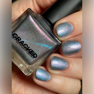 Cracked Polish continues their 'Follow Me Down The Indie Rabbit Hole' for the holidays with a polish inspired by the White Queen’s ethereal grace, this shade captures the icy mystique of her dress and delicate accessories!

"Icy Elegance" is an icy grey lavender, kissed with silver shimmers and a soft ice-blue magnetic pigment, it’s a frosty masterpiece that’s both regal and refreshingly cool.