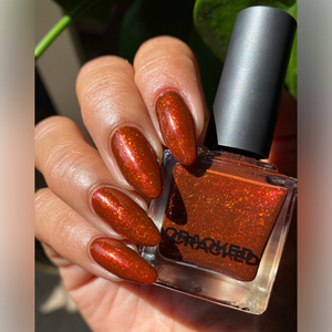 For Halloween, Cracked Polish has created a polish inspired by the Queen of Hearts from Alice in Wonderland's quote, "Off with her head!!"

"Clotted" is a deep, warm red polish that's enriched with gold and copper shifting flakes and red shimmers.