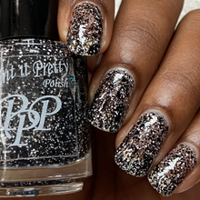 "Licorice Layers" has a clear base with assorted white and black glitters and flakes.

15ml Bottle