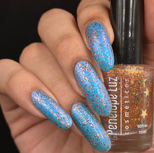 Penelope Luz continues the series inspired by Dynamic Duos with "Rochelle" which is a vibrant blue base with blue/violet aurora shimmer, and Julius" which is has orange/gold iridescent flakes and orange holo glitters. 10ml bottles.  150 duo cap